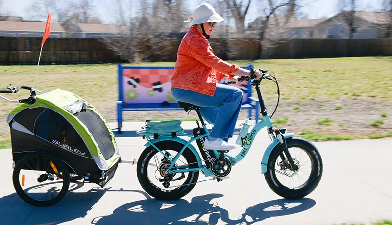 Traceyrené had trouble controlling her e-bike throttle with her thumb before her surgery. Now she loves crusiing on the Lakewood Gulch Trail near her home with her grandson Jermaine in tow. Photo by Cyrus McCrimmon for UCHealth.