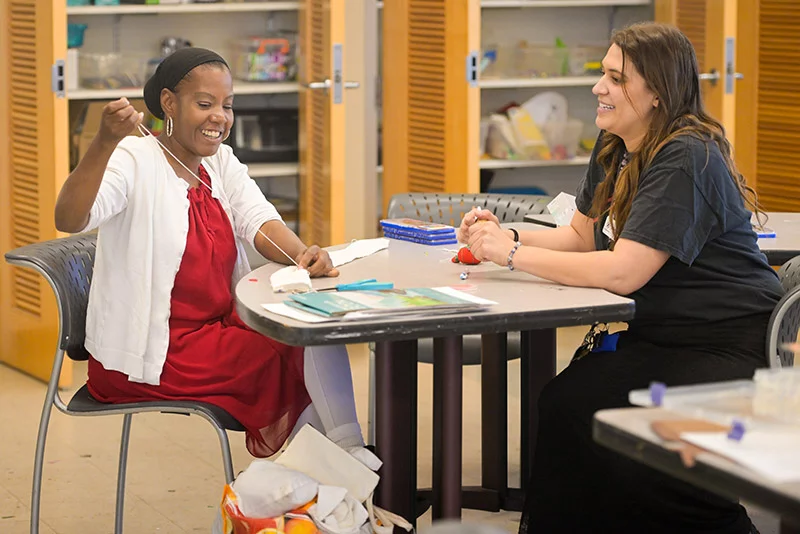 Alayya works on a sewing project at The Gathering Place. Megan Kaley, right, assisted her. Photo by Cyrus McCrimmon, for UCHealth