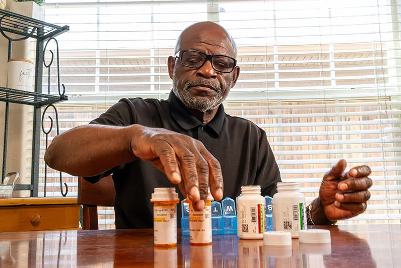 Senior man sorting his medications. As people age, the number of prescription medications, over-the-counter drugs and supplements they take often increases, which raises the risk of harmful drug interactions and side effects. Photo: Getty Images.
