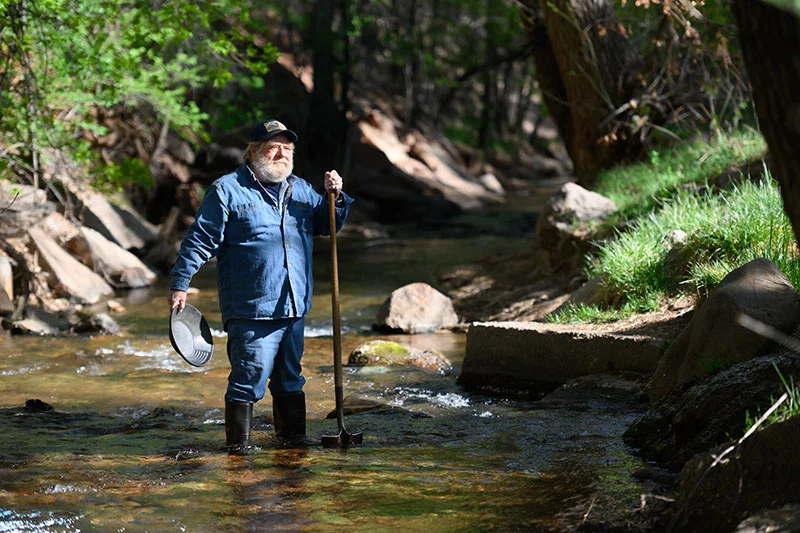 Golden’s research into Colorado history launched his interest in gold prospecting. He studied old newspapers, then created a large board where he mapped out news events from the 1800s, including gold strikes. He also studied the properties of gold and sediment to understand how they travel downstream in creeks and rivers. Photo by Mark Reis, for UCHealth