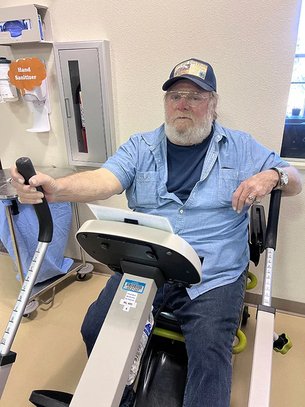 Golden credits pulmonary rehabilitation for enabling him to reduce his need for supplemental oxygen after surgery. He regularly rides the exercise bike. Photo by Joanna Bean, UCHealth.