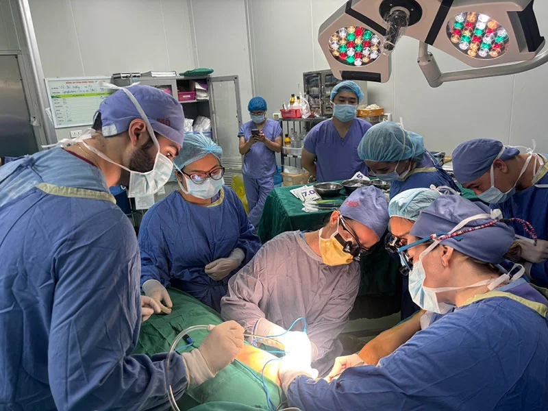 Dr. Katie Egan, an assistant professor of plastic and reconstructive surgery, performs a free-flap microsurgery in a Hanoi hospital in Vietnam. Photo courtesy of Dr. Mark Greyson.