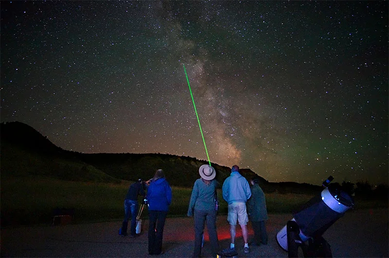 A park ranger identifies a constellation for park visitors attending a stargazing program in Rocky Mountain National Park. Photo by Jeff Zylland, National Park Service.