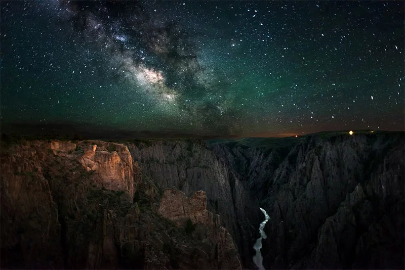 A star-filled night sky fames the dynamic gorge of the Black Canyon of the Gunnison National Park. Photo by G. Owens, National Park Service.
