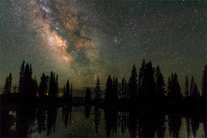 A dark, star-filled sky stretches over Gunnison National Forest, a remote setting ideal for stargazing in Colorado. Photo by Dawn Wilson, UCHealth.