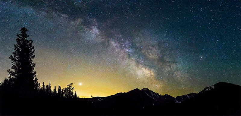 A starry sky stretches over Bear Lake in Rocky Mountain National Park, a popular spot for viewing Colorado’s night skies. Photo by Dawn Wilson, UCHealth.