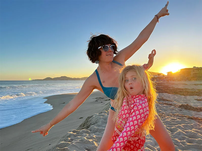 Kate on a beach with her daughter. Kate never stopped fighting — through surgery, rounds of chemotherapy and a immunotherapy treatment that helped her survive a rare salivary gland cancer. Now cancer-free, she is focused on the life she fought to keep, spending time with her daughter, Runi, and embracing every moment together. Photo courtesy of Kate Showalter.