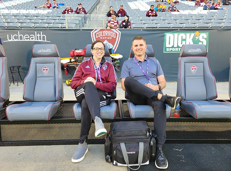 Colorado Rapids team doctors, Dr. Rachel Frank, and UCHealth orthopedic surgeon, left, and Dr. Jack Spittler, tend to players at a game. Photo courtesy of Dr. Jack Spittler.