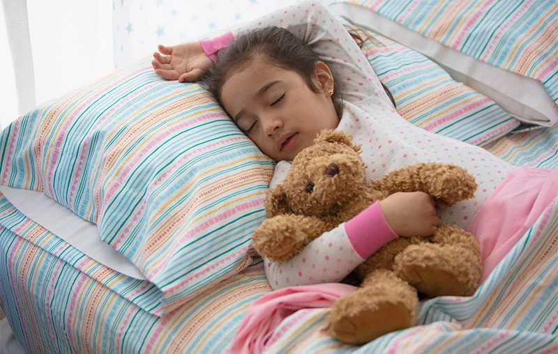 A child sleeping in bed. Up to 5% of children are impacted by pediatric obstructive sleep apnea, which can disrupt healthy growth and affect learning, behavior and overall well-being. Photo: Getty Images.