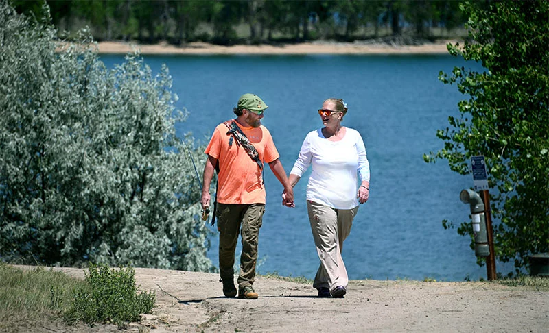 Matt and Healther walking down a sidewalk holding hands. Matt and Heather met in kindergarten in their hometown of New Brighton, Penn., and dated after high school. They married in 1997. They have a son, Zachary, who’s in the Navy. Photo by Sonya Doctorian, UCHealth.