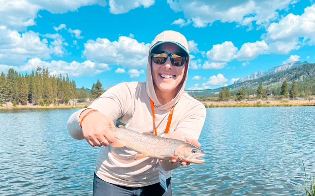 Karissa Goossen holding a fish she caught. A Wyoming native and outdoor enthusiast, Karissa Goossen persevered through breast cancer, thyroid cancer and ongoing cancer surveillance after learning she carries a CHEK2 gene mutation. Photo courtesy of Karissa Goossen.