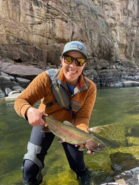Karissa holding a fish in a canyon. An avid fly fisher, Karissa Goossen was frustrated when a knee injury sidelined her from her favorite outdoor pursuits shortly before her cancer journey began. Photo courtesy of Karissa Goossen. 