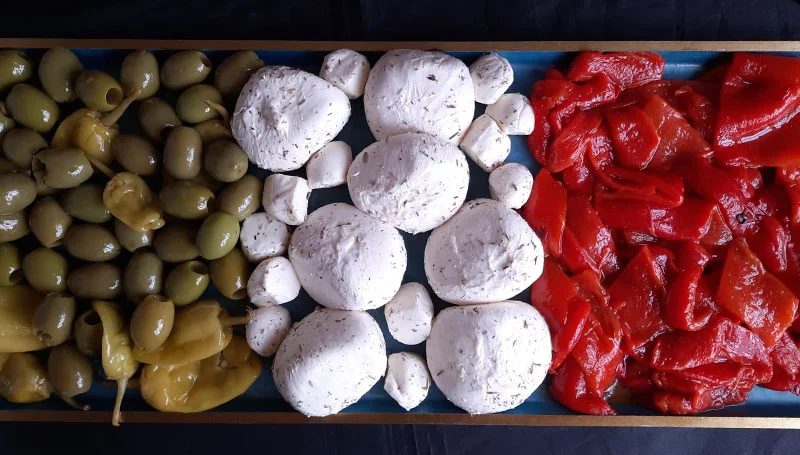 An antipasto platter of green olives, white cheese and smoked red peppers laid out to echo the colors of the Italian flag. Photo by Bill St. John, for UCHealth.