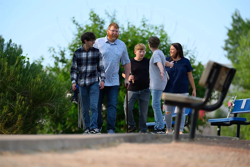 John Mazanec with family. By the spring after his motorcycle accident, John was using crutches to walk, then a cane. Paramedics had just started stocking whole blood on their ambulances, which likely saved John's life. Photo by Mark Reis for UCHealth.