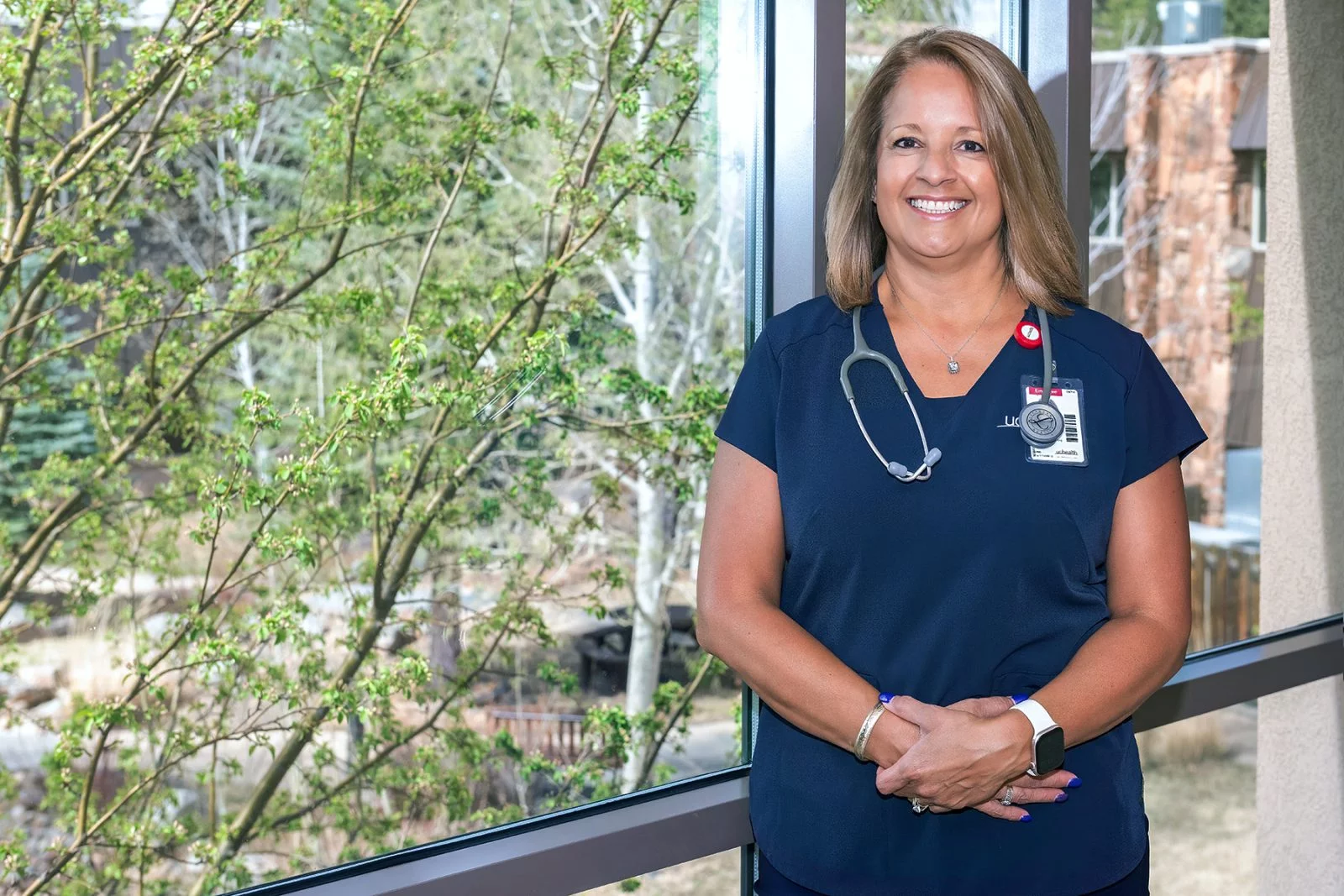 Lidia Burreson stands near a window at UCHealth Estes Valley Medical Center