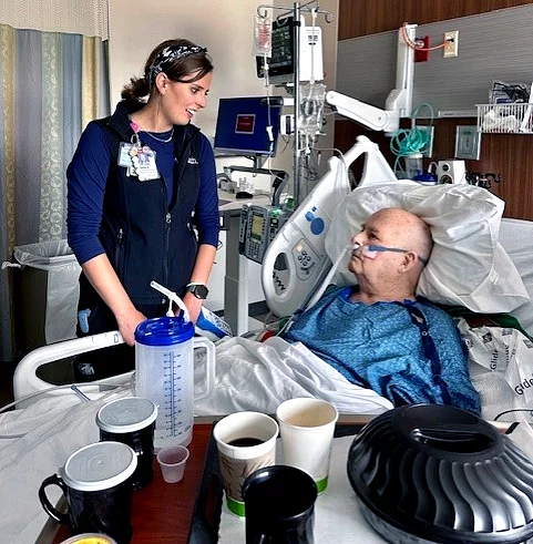 Nurse Julia Anderson talks with patient Duane "Shorty" Lankford at the bedside at UCHealth Poudre Valley Hospital.