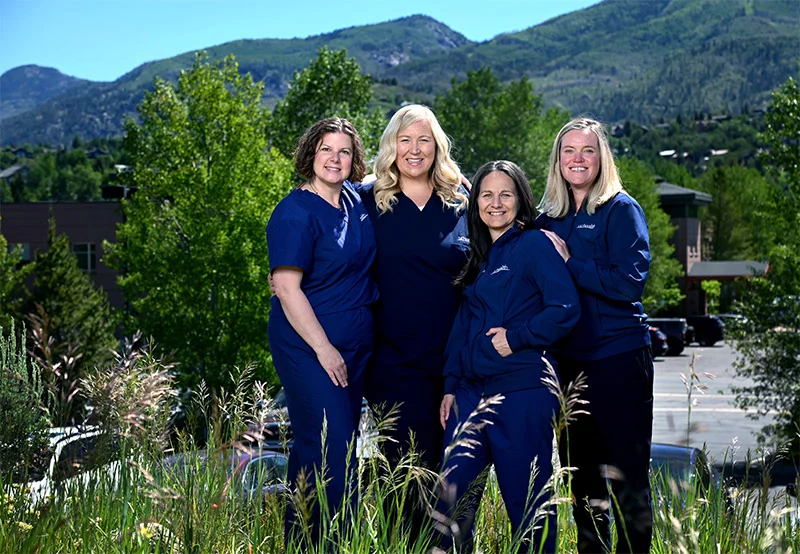 Four nurses stand outside Yampa Valley Medical Center on a sunny dayFrom left, Edie Seffrood, Jenny Pryzymus, Sarah Clemmons and Maureen Connolly stand outside UCHealth Yampa Valley Medical Center in Steamboat Springs. Photo by Sonya Doctorian, UCHealth.