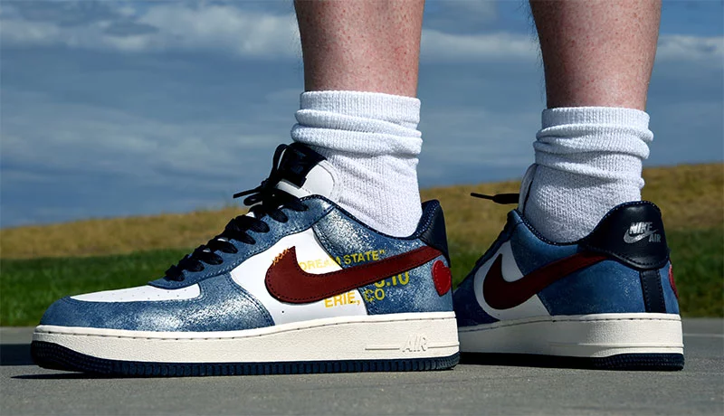 Ted D'Arcy's custom Nike Air Force Ones, designed by Marcus from Sicario Studios, include symbols tied to his journey as a patient. Red accents honor his heart donor while the leather heart symbolizes the his family and gold stitching represents Ted's community. The blue nubuck symbolizes the dream state he described throughout his journey. Photo by Sonya Doctorian, UCHealth.