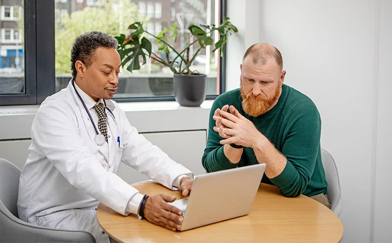 man going over test results with his doctor. Many symptoms that people attribute to low testosterone can have other causes. Doctors typically recommend careful testing and evaluation before considering testosterone replacement therapy. Photo: Getty Images.