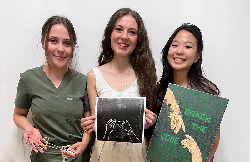 Victoria Gonzales, Madi Clements and Jessica Woon, from left, made art a part of their medical school training. They organized an art show for their classmates and the UCHealth doctors they worked with during the year, and created pieces of their own. Making art a part of medical school training improves students' resiliency and makes them better doctors, experts say. Photo by Joanna Bean, UCHealth.