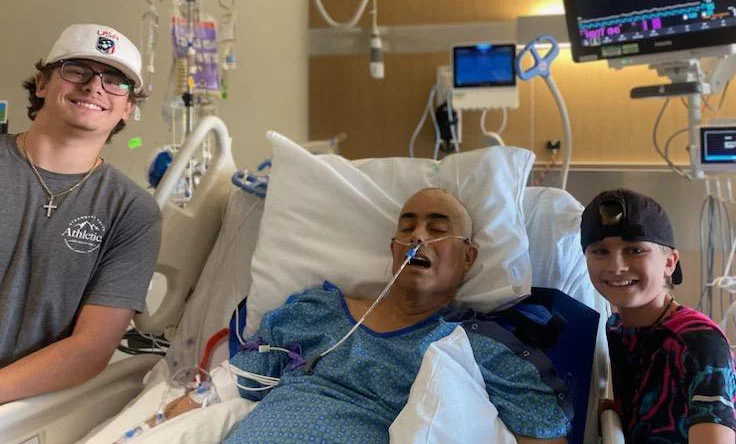Abbott (left) and Preston (right) Gautreaux with their dad, Eric, following Eric’s emergency craniotomy at UCHealth University of Colorado Hospital. Photo courtesy of Eric Gautreaux.