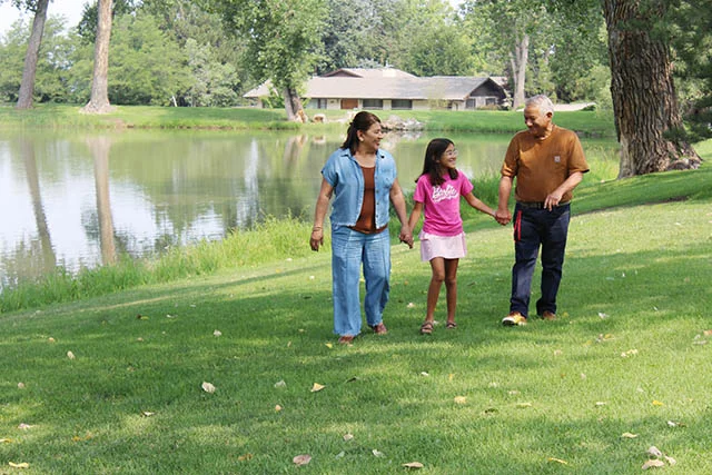 Ramon Cordoba (right) walks with his wife, Maria (left), and his granddaughter around a lake in Greeley, Colorado. Photo: Ana Gretchen Robleto, UCHealth.