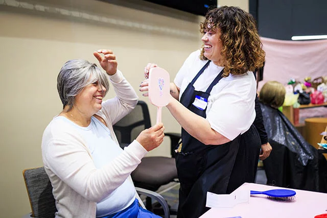Claudia Carrillo laughed as she tried on a wig at the Nadie Lucha Sola event for cancer survivors at UCHealth University of Colorado Hospital. During the event, Claudia cried as she began to lose clumps of hair due to chemotherapy. Photo by Michael Ciaglo, for UCHealth.