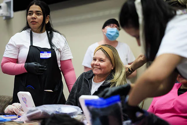 Marta Vasquez tried on wigs in different colors, ultimately going with a brown wig that was similar to her natural color. She appreciated the love and support she felt at the Nadie Lucha Sola event on Oct. 10 at UCHealth University of Colorado Hospital. Photo by Michael Ciaglo, for UCHealth.