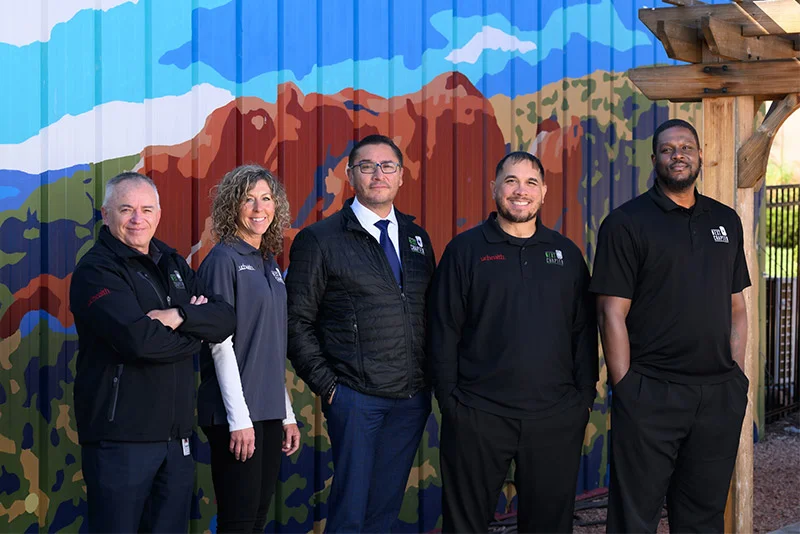 The Next Chapter offices near downtown Colorado Springs feature a peaceful, wooded backyard with colorful murals. The Next Chapter team includes, from left, Damian McCabe, director of behavioral health and military affairs for UCHealth in southern Colorado and a 24-year veteran of the U.S. Air Force and U.S. Army; Lori Montano, who runs UCHealth’s co-response program in southern Colorado; Jose Ramirez, a Green Beret who served 25 years in the U.S. Marines and U.S. Army; Miguel Lopez, an Army veteran and Purple Heart recipient; and Rodger Johnson, who served 12 years in the Army and now works as a liaison to Next Chapter with Mt. Carmel Veterans Services Center. Photo by Mark Reis, for UCHealth.